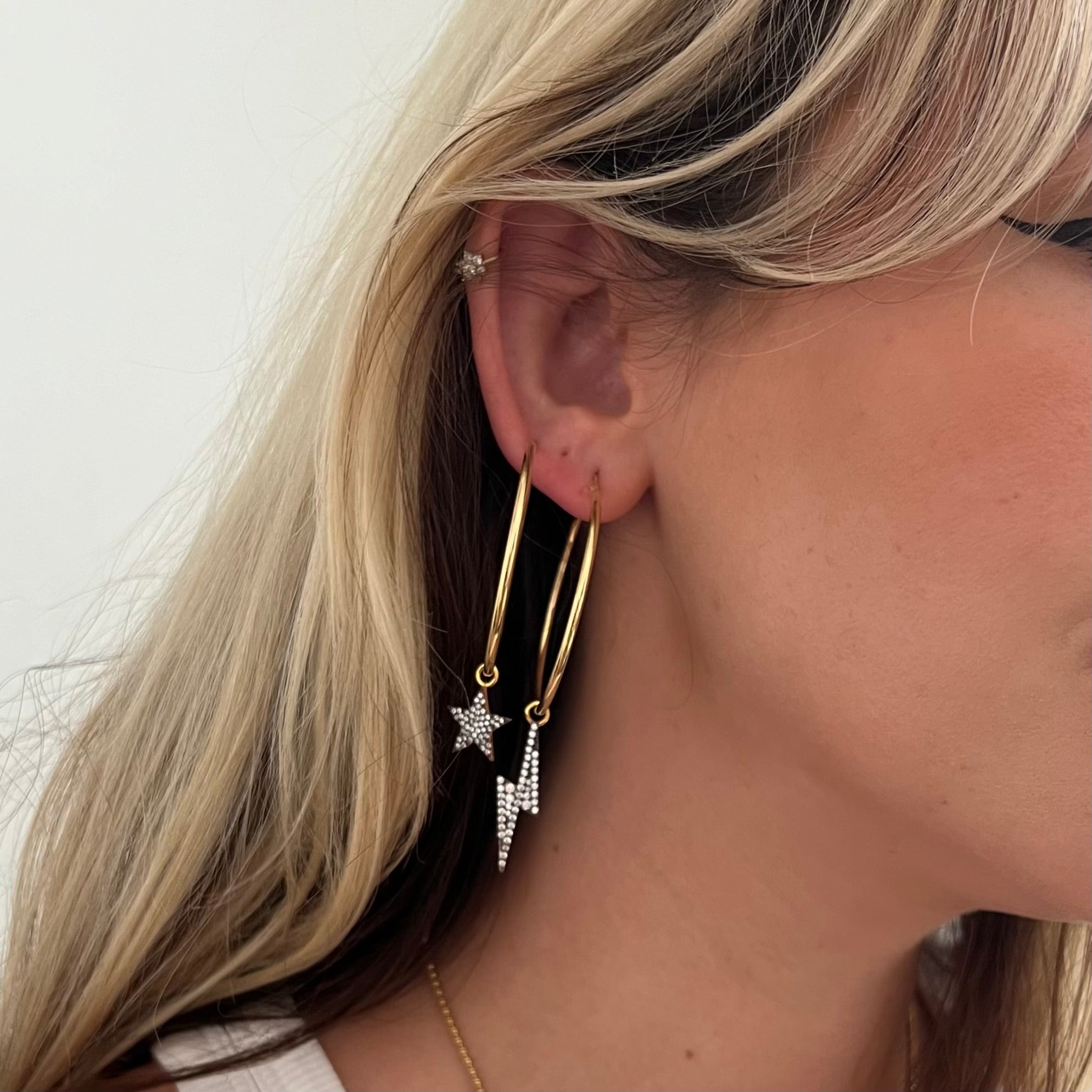18kt gold plated sterling silver Bowie hoop earrings with detachable cosmic grey diamanté star and lightning bolt charms in mixed metal finish by Angel Rocks