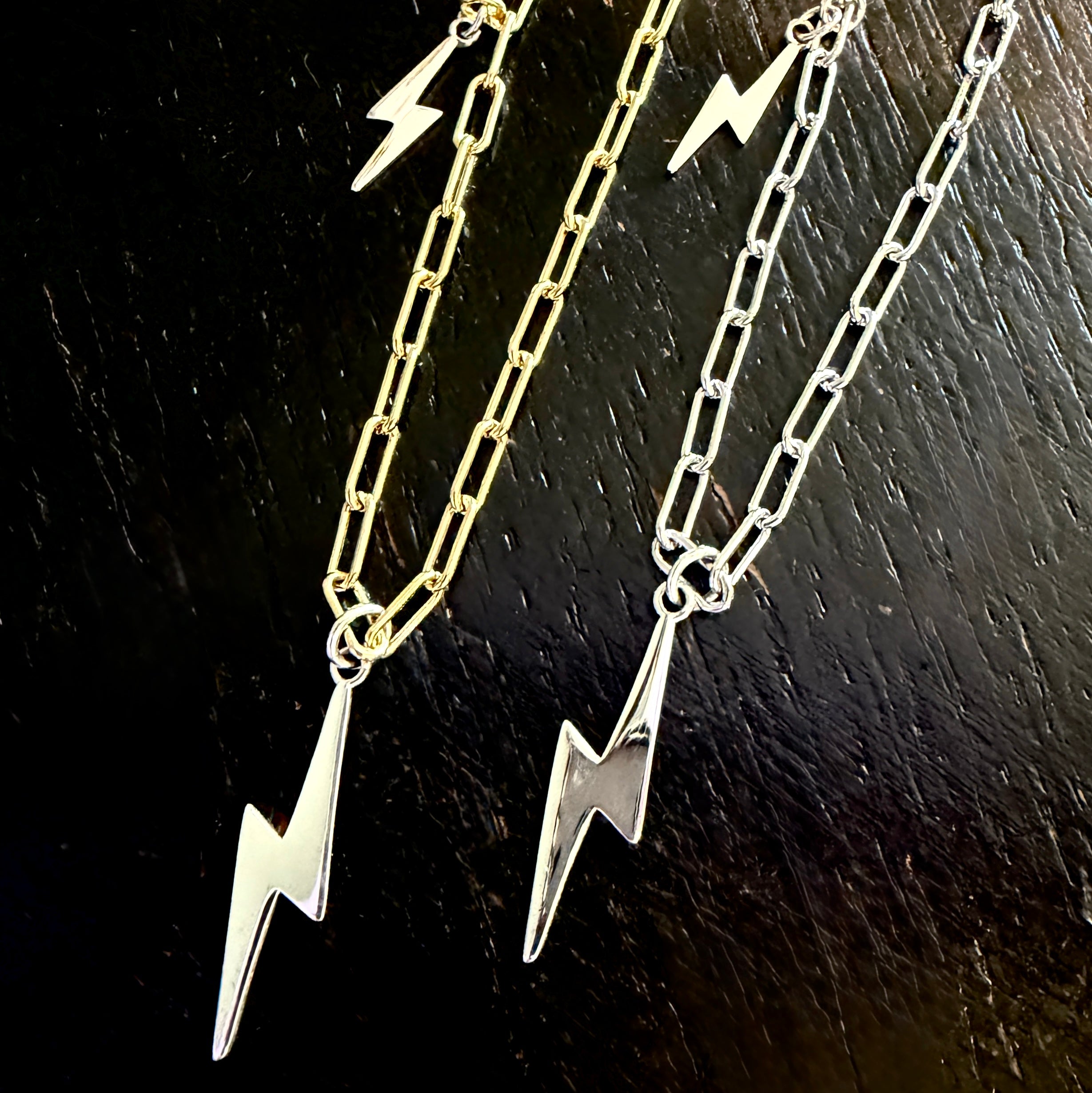 18kt gold plated sterling silver Bowie necklace with silver lightning bolt and mini charm pendants on adjustable chain by Angel Rocks