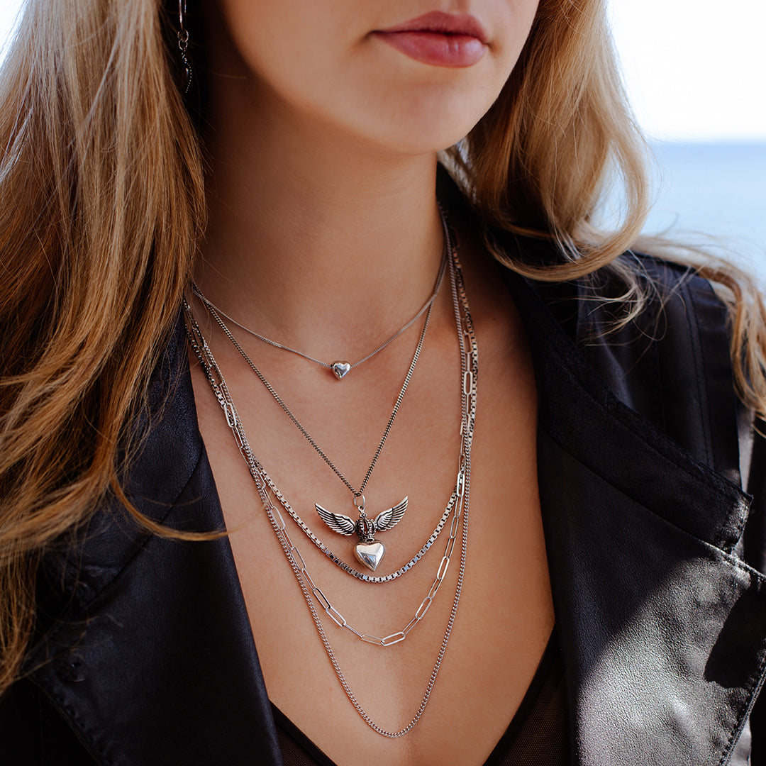 Sterling silver Divine Heart necklace with angel wings and crown pendant on adjustable snake chain, paired with silver little love bubble small heart chain and silver multi chain necklace, statement jewellery by Angel Rocks