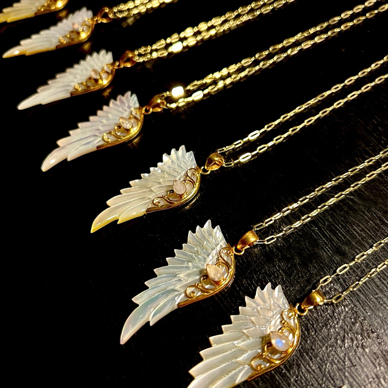 Gold hand carved wing necklace with mother of pearl pendant and moonstone detail on 18kt gold plated sterling silver chain, statement jewellery by Angel Rocks