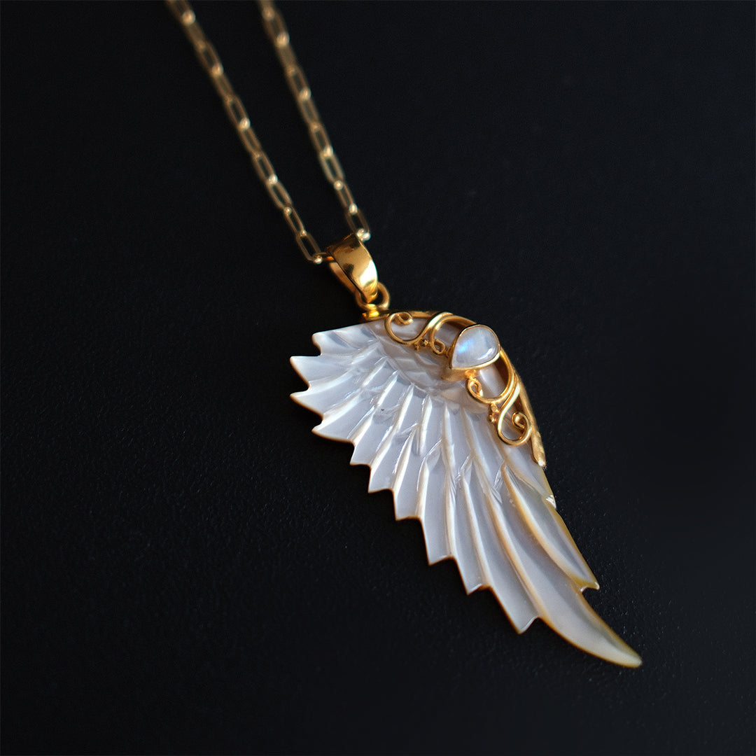 Gold hand carved wing necklace with mother of pearl pendant and moonstone detail on 18kt gold plated sterling silver chain, statement jewellery by Angel Rocks