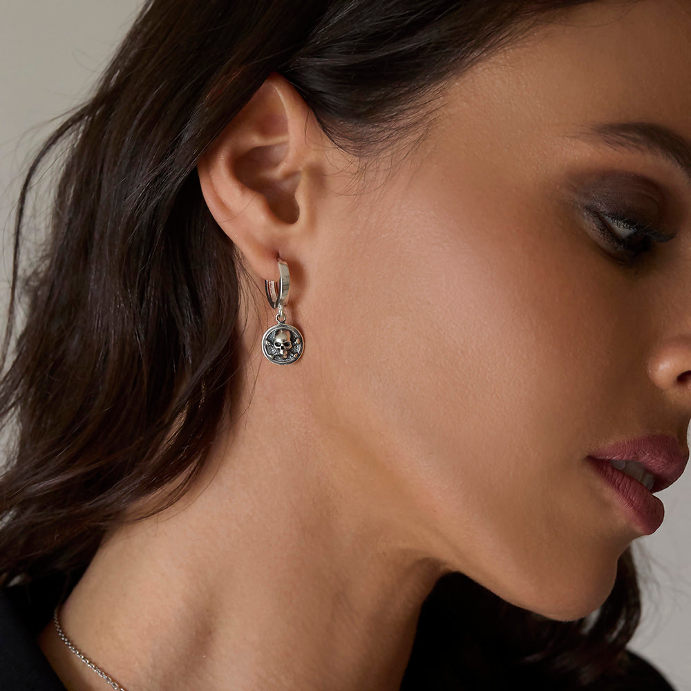 Sterling silver skull huggie hoop earring with chunky coin detail and hinged fastening, handmade rock n roll style by Angel Rocks