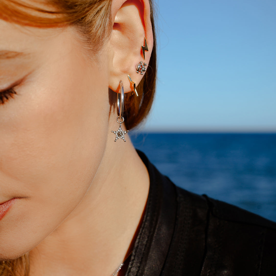 Sterling silver hoop earrings with detachable starburst and bolt charms set with clear diamantés in a vintage grey finish by Angel Rocks