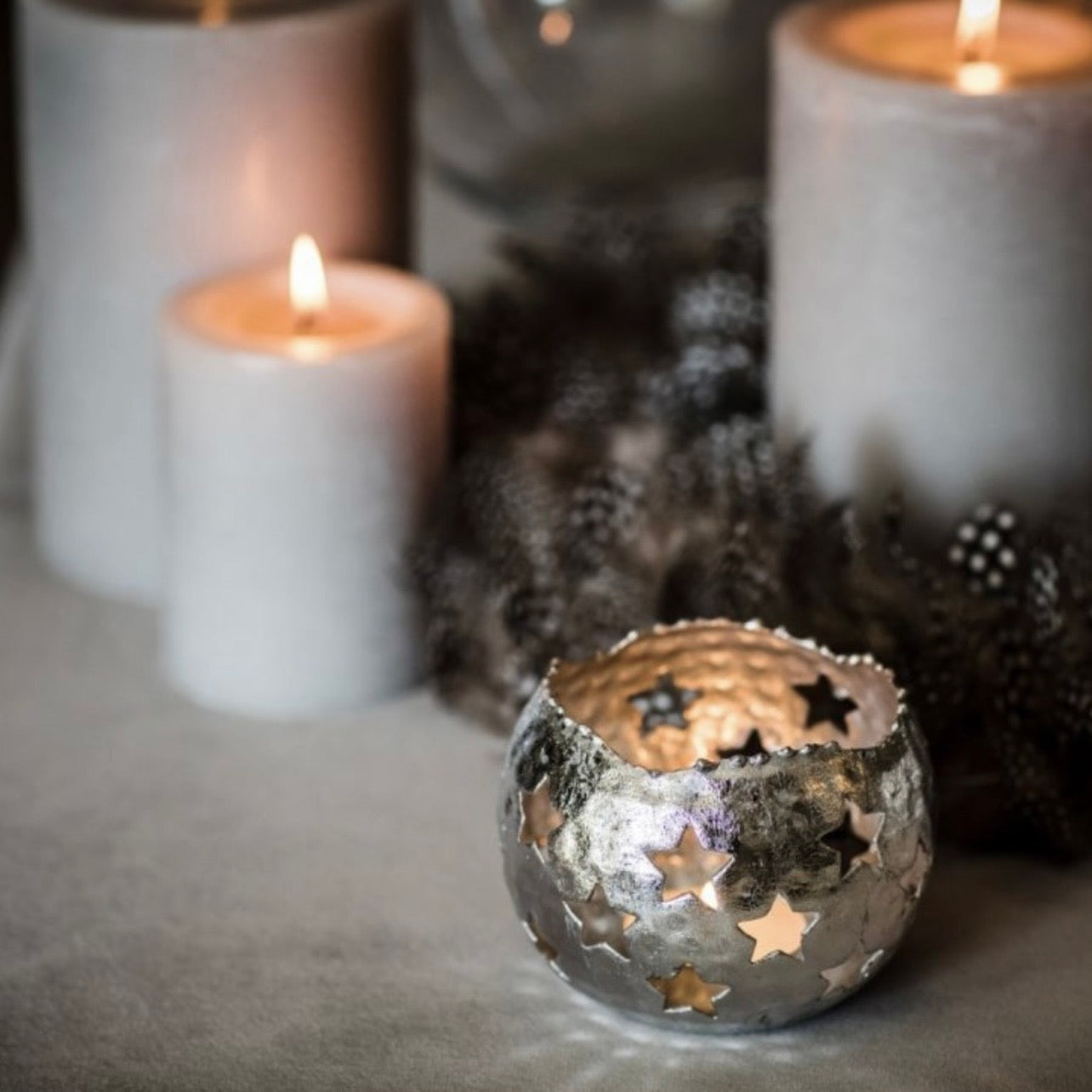 Set of three silver star shaped iron tea light holders with cut out star details for candlelight effect by Angel Rocks