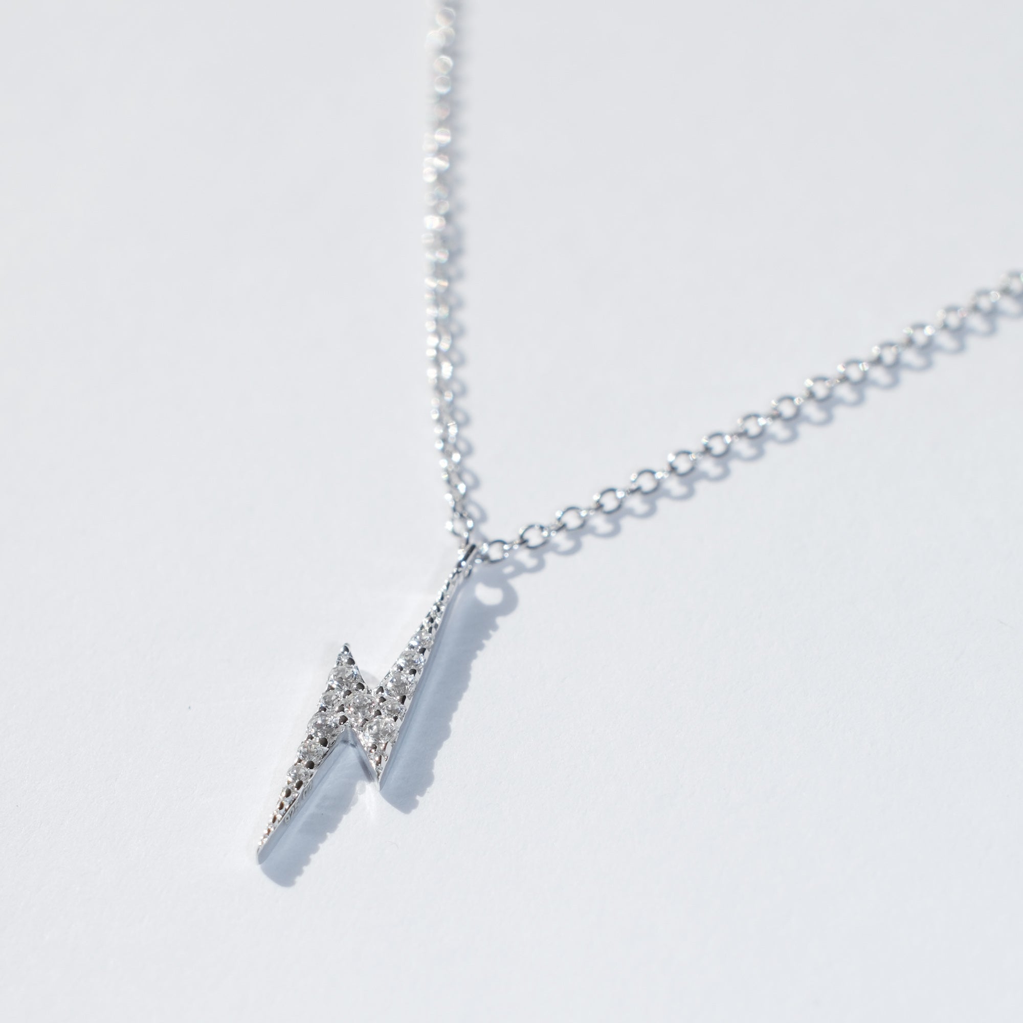 Sterling silver tiny lightning bolt necklace with cubic zirconia diamanté detail on fine adjustable chain by Angel Rocks