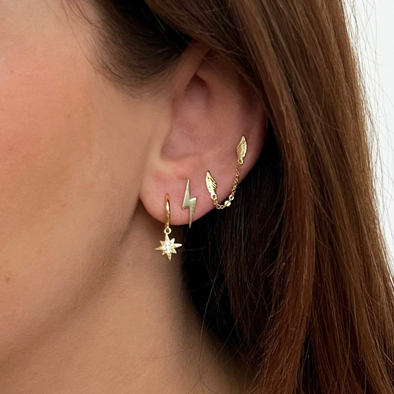 18kt gold plated sterling silver double wing chain stud earrings designed for multiple piercings with delicate connecting chain by Angel Rocks