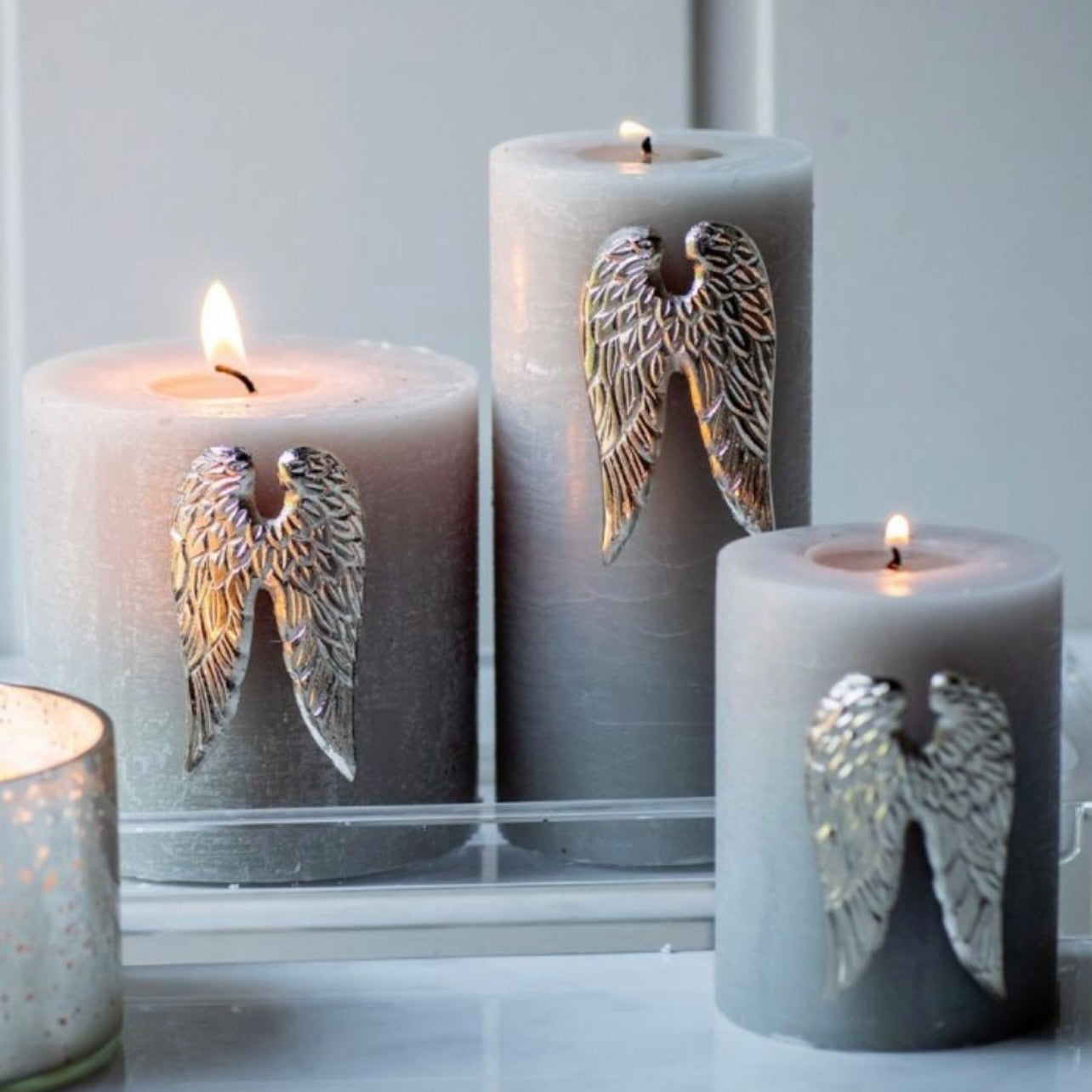 Set of three angel wing candle pins in nickel plated aluminium designed for decorative church candles by Angel Rocks