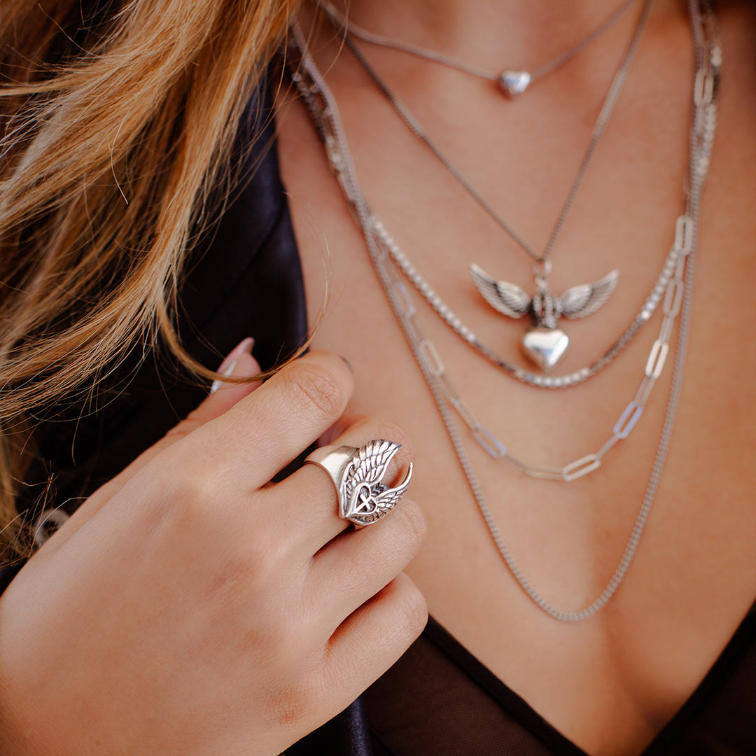 Sterling silver Divine Heart necklace with angel wings and crown pendant on adjustable snake chain, paired with multi chain silver necklace and little love bubble small heart necklace, statement jewellery by Angel Rocks