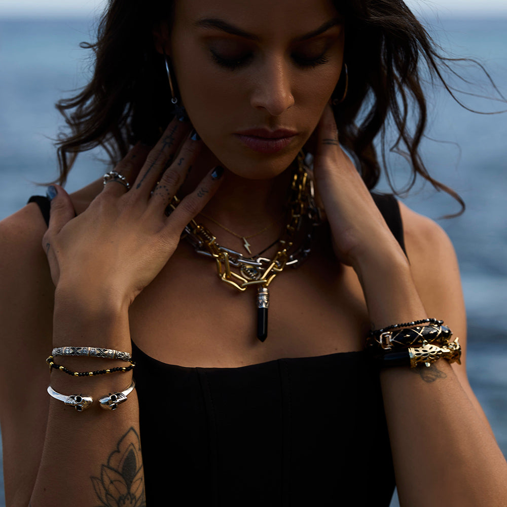 Black Onyx goddess necklace with crystal point pendant set in sterling silver and 18kt rose gold on chunky chain, styled with other chunky necklaces, statement healing jewellery by Angel Rocks