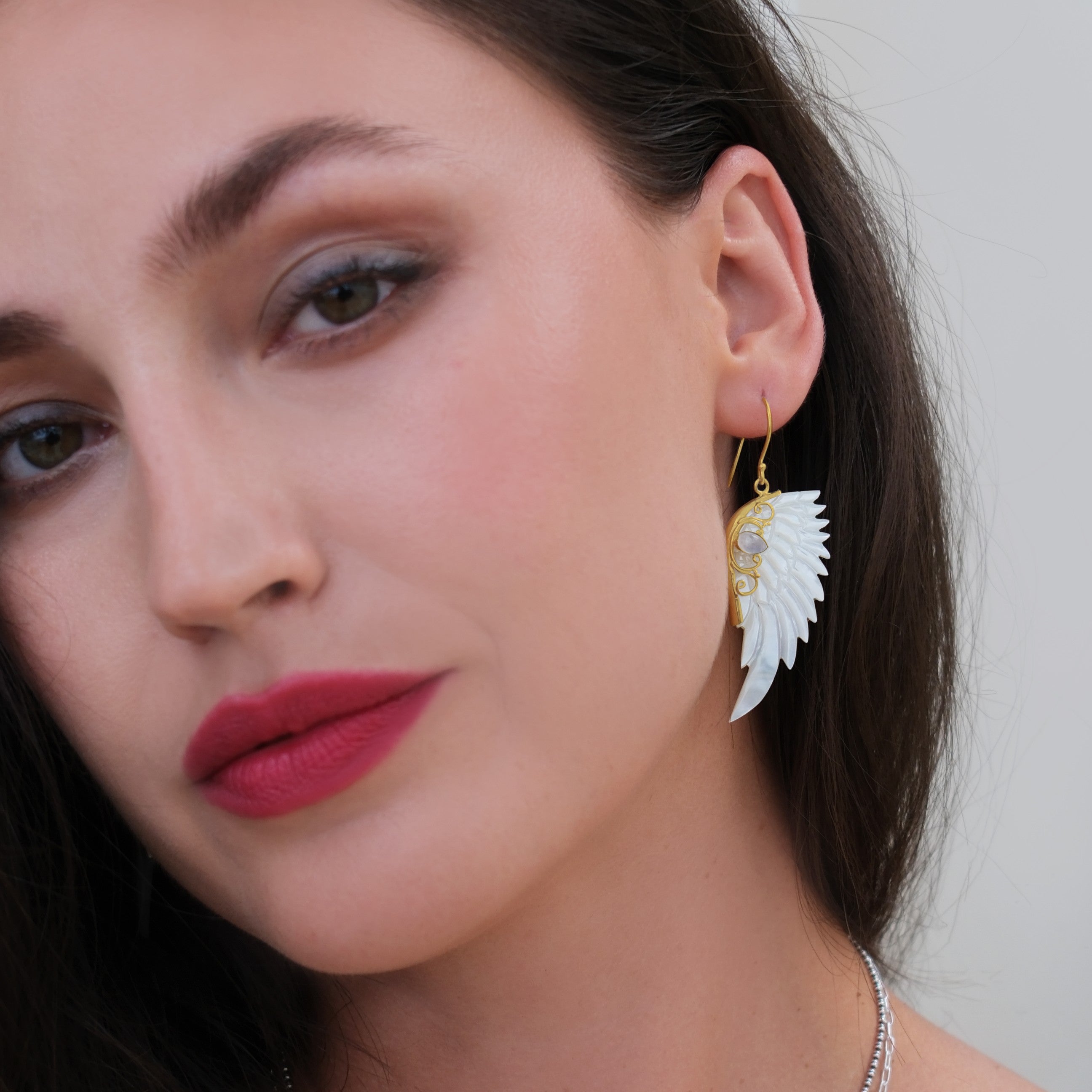 Hand carved mother of pearl angel wing earrings set in 18kt gold plated sterling silver by Angel Rocks