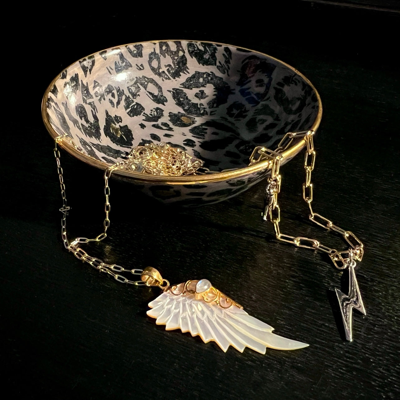 Gold hand carved wing necklace with mother of pearl pendant and moonstone detail on 18kt gold plated sterling silver chain, statement jewellery by Angel Rocks