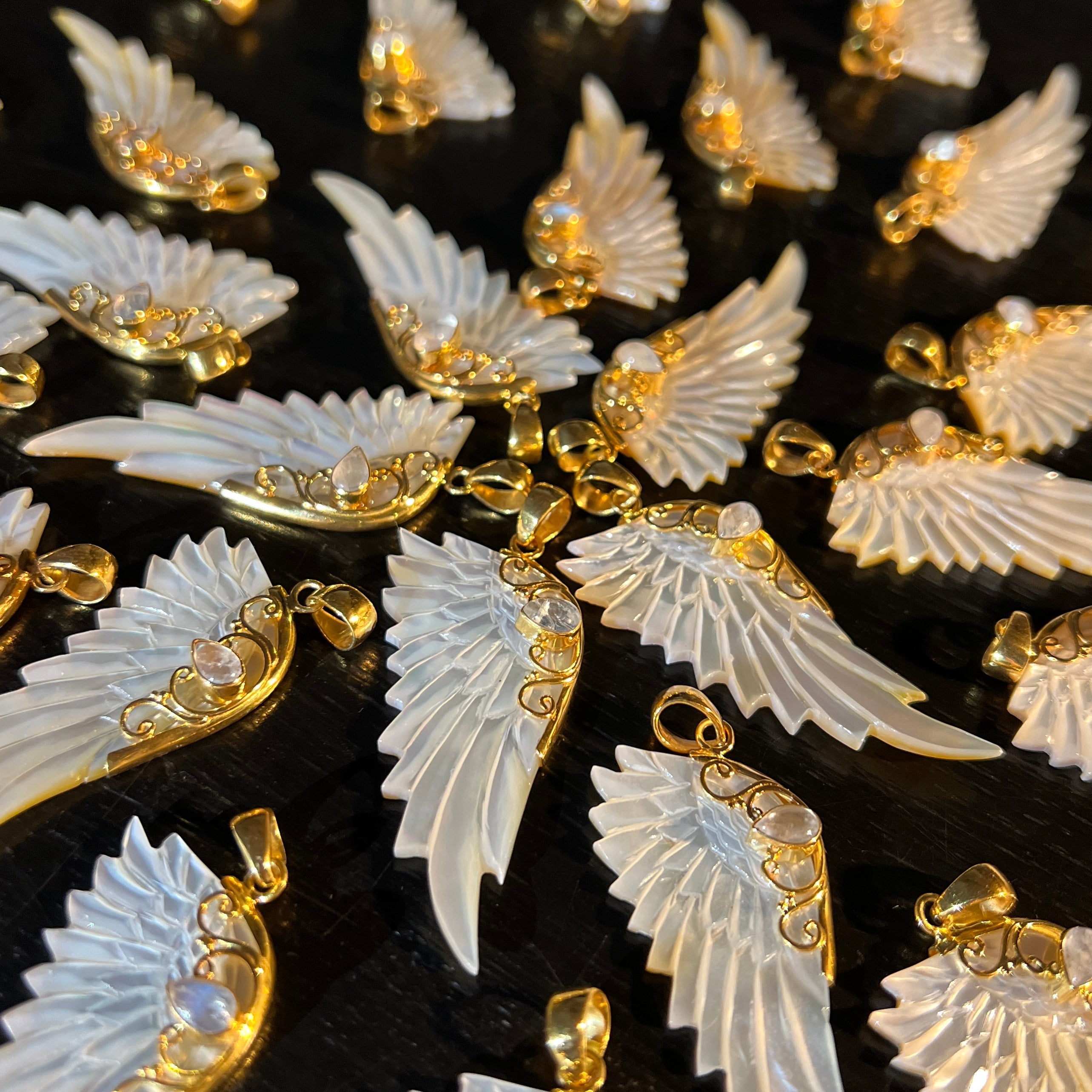 Gold hand carved wing necklace with mother of pearl pendant and moonstone detail on 18kt gold plated sterling silver chain, statement jewellery by Angel Rocks