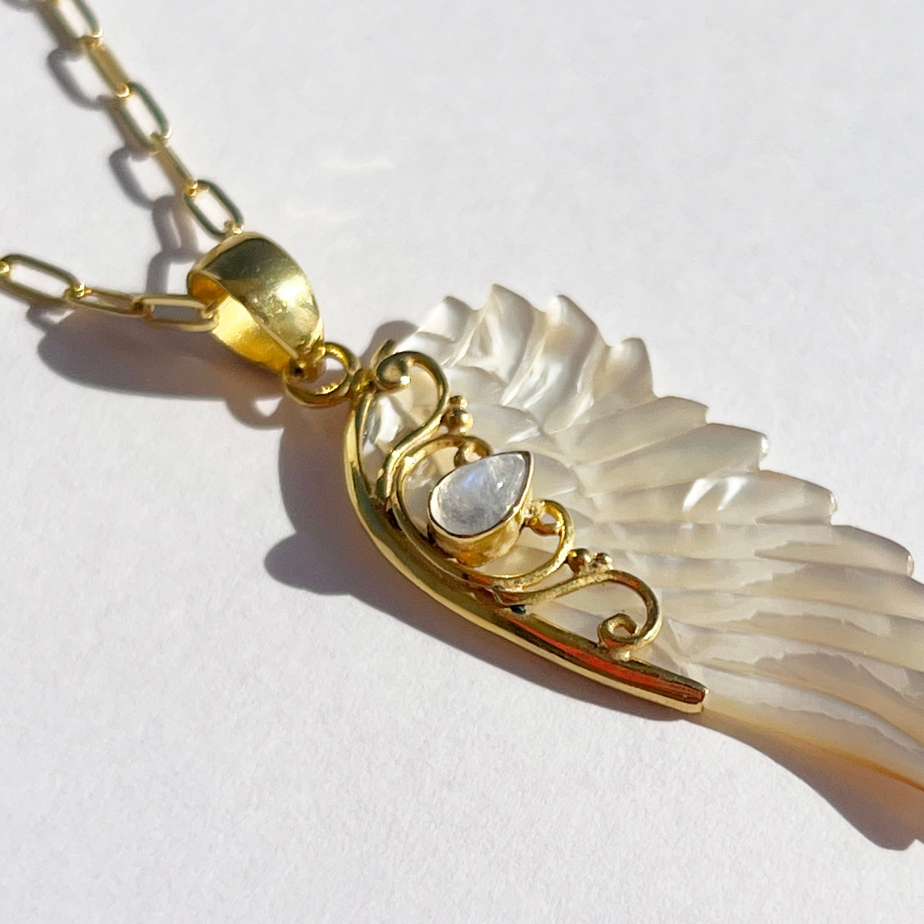 Gold hand carved wing necklace with mother of pearl pendant and moonstone detail on 18kt gold plated sterling silver chain, statement jewellery by Angel Rocks