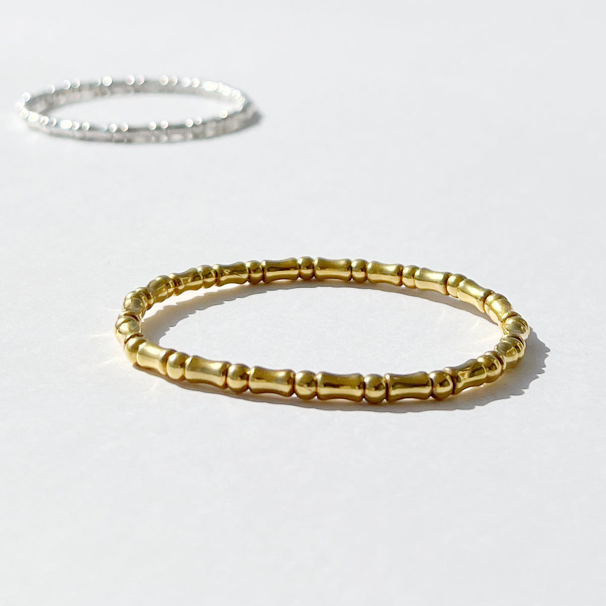 18kt gold plated sterling silver mini bones stretch bracelet, stackable design bracelet for layered styling by Angel Rocks
