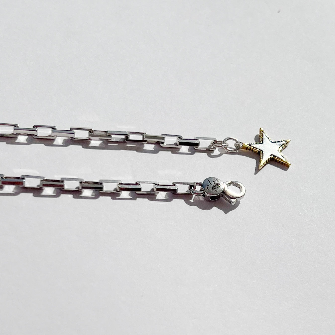 Rock Star lariat necklace with sterling silver chain, gold-edged star charm and adjustable long chain detail by Angel Rocks