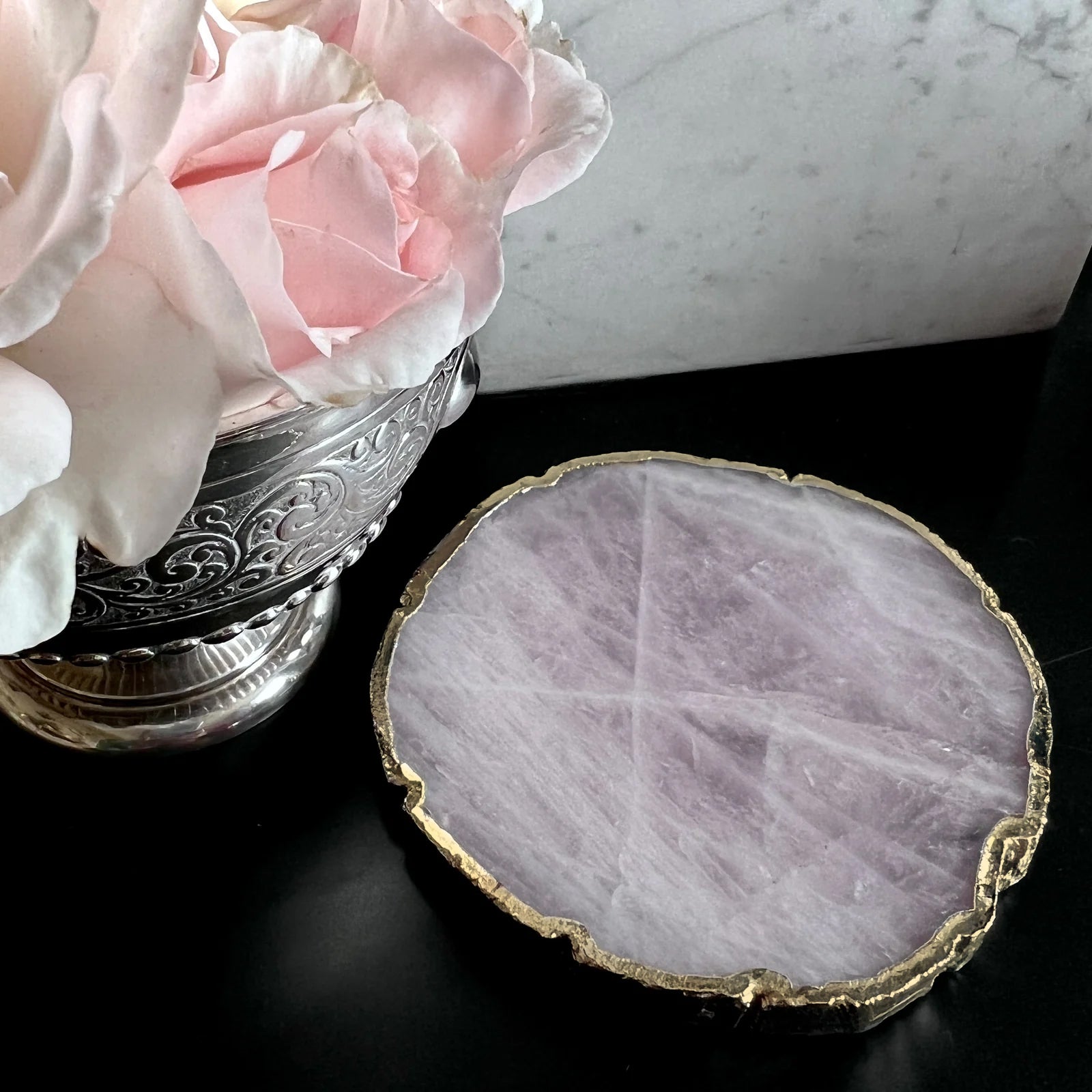 Rose quartz crystal coaster with gold edge detail, used as a candle stand or drinks mat by Angel Rocks