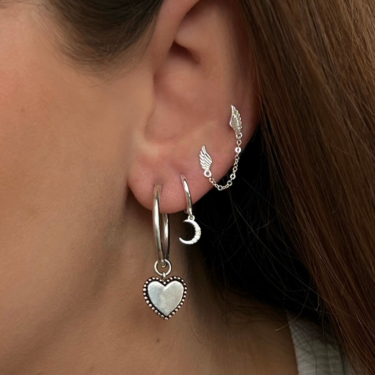 Sterling silver star and moon celestial huggie hoop earrings with cubic zirconia detail by Angel Rocks