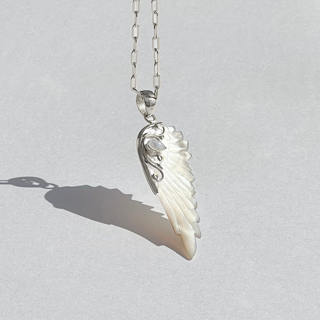 Sterling silver hand carved wing necklace with mother of pearl pendant and moonstone detail sterling silver chain, statement jewellery by Angel Rocks