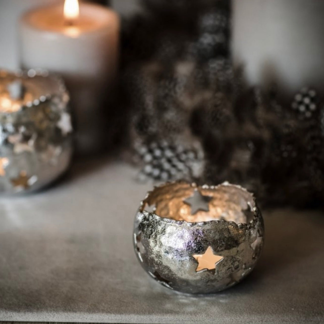 Set of three silver star shaped iron tea light holders with cut out star details for candlelight effect by Angel Rocks